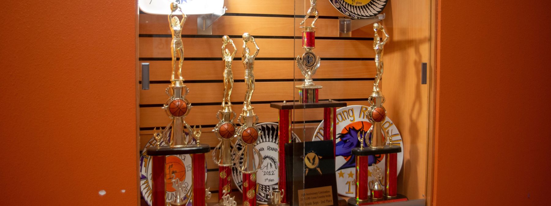 basketball trophies in case in school hallway