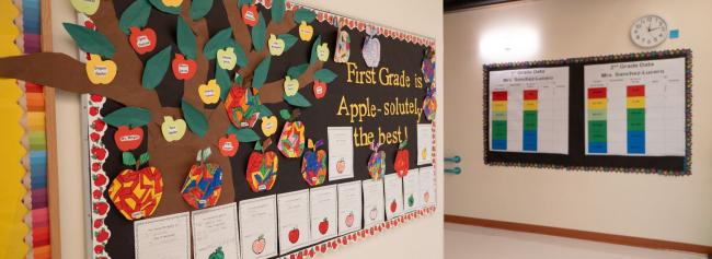 School hallway adorned with students projects on the bulletin boards.